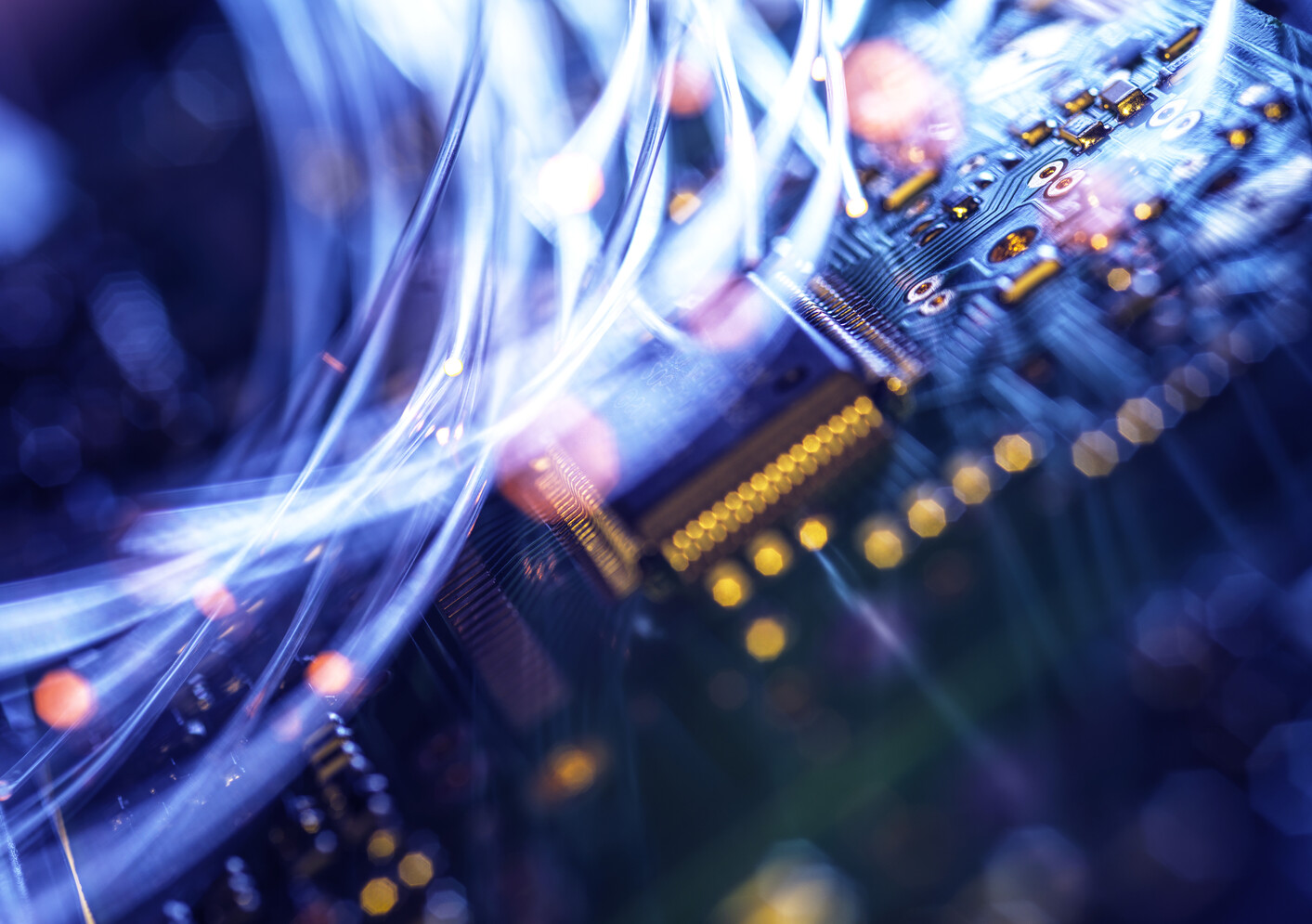 Fibre optics carrying data passing through electronic circuit boards, close up